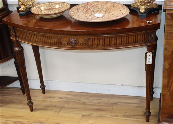 A George III style mahogany bow front console table W.110cm